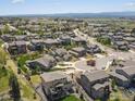 Expansive aerial view showcases a meticulously planned residential neighborhood nestled near the rolling hills and distant mountains at 4780 W 108Th Pl, Westminster, CO 80031