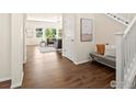 Inviting entryway with hardwood floors, adjacent living area, bench seating and abundant natural light at 4780 W 108Th Pl, Westminster, CO 80031