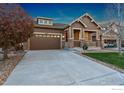 Inviting single-Gathering home with a well-maintained lawn and cozy front porch at 4967 S Ukraine St, Aurora, CO 80015