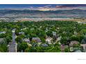 Captivating aerial shot showcases the neighborhood, nearby lake and stunning mountain views at 5354 Muirfield Ct, Boulder, CO 80301