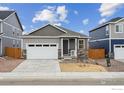 Charming single-Gathering home showcasing stone accents, attached garage, and manicured landscaping at 6500 13Th St, Frederick, CO 80530