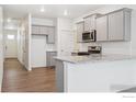 Modern kitchen featuring stainless steel appliances, granite countertops, and ample cabinet space at 6500 13Th St, Frederick, CO 80530