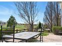 Private patio with dining set overlooking the golf course and green space at 665 Glenarbor Cir, Longmont, CO 80504