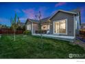 Well-maintained backyard with lush green grass and a concrete patio, perfect for outdoor gatherings at 719 Wagon Bend Rd, Berthoud, CO 80513