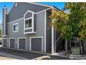Exterior view of a gray condo building featuring a private garage at 7452 Singing Hills Dr, Boulder, CO 80301