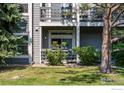 Charming two-story condo exterior with a patio and lush landscaping at 7452 Singing Hills Dr, Boulder, CO 80301