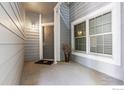 Inviting front porch with a stylish door, window, and pleasant light fixture at 7452 Singing Hills Dr, Boulder, CO 80301
