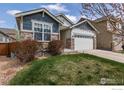 Charming home with stone accents, a two-car garage, and a well-maintained lawn at 850 Prairiestar Dr, Berthoud, CO 80513