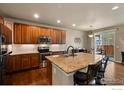 Spacious kitchen featuring a large island with seating and stainless steel appliances at 850 Prairiestar Dr, Berthoud, CO 80513