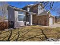 Well maintained, two-story home boasting a combination of siding and stone accents in a landscaped yard at 9436 Cody Dr, Broomfield, CO 80021
