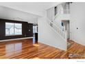 Bright living room with hardwood floors, a staircase, and large windows for plenty of natural light at 9436 Cody Dr, Broomfield, CO 80021
