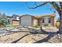 Charming brick home featuring a two-car garage and a well-maintained front yard at 9655 W 105Th Way, Broomfield, CO 80021