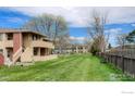 Expansive backyard with lush lawn, mature trees, and fencing offers privacy, recreation, and outdoor enjoyment at 1100 Bacchus Dr # A, Lafayette, CO 80026