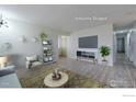 Virtually staged living room showcasing stylish furniture on sleek wood floors, with view of the hallway to bedrooms at 1100 Bacchus Dr # A, Lafayette, CO 80026