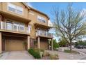 Townhome exterior with attached garages, second story balconies, and manicured landscaping at 12820 King St, Broomfield, CO 80020