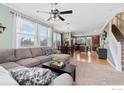 Bright living room with a large sectional couch, view to the kitchen, and plenty of natural light at 12820 King St, Broomfield, CO 80020