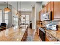 Gourmet kitchen boasts granite counters, stainless appliances, and an open layout perfect for entertaining at 14394 W 88Th Dr # C, Arvada, CO 80005