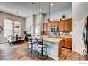 Stylish kitchen featuring granite countertops, wooden cabinets, and stainless steel appliances at 14394 W 88Th Dr # C, Arvada, CO 80005