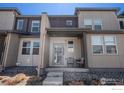 Charming townhome with a welcoming front porch and neutral-toned facade at 16058 E Elk Dr, Denver, CO 80239