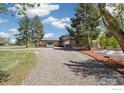 Charming single-Gathering home featuring a two-car garage, stone accents, long driveway and mature trees at 1866 Mountain View St, Erie, CO 80516