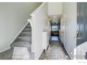 Bright entryway with staircase, neutral walls, and view into the inviting living area at 1978 E 102Nd Cir, Thornton, CO 80229