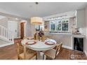 Bright dining area with wood floors, stylish lighting, and an adjacent kitchen at 2050 Walnut St, Boulder, CO 80302