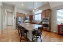 Features a central island, a large pantry, and a view of the breakfast room at 2196 Winding Dr, Longmont, CO 80504
