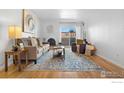 Bright living room with a decorative fireplace, balcony access, cozy furniture, and stylish accents at 252 N Pennsylvania St # 305, Denver, CO 80203