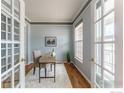 Bright home office featuring French doors, wood floors, a stylish desk, and a large window at 2822 Flint Ct, Superior, CO 80027