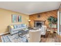 Inviting living room with a stone fireplace, wood-paneled wall, and comfortable seating at 3030 Oneal Pkwy # 18, Boulder, CO 80301