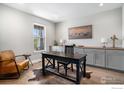 Comfortable office featuring custom cabinets and a rustic desk at 3295 Heron Lakes Pkwy, Berthoud, CO 80513