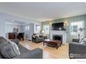Bright living room boasts a fireplace, hardwood floors, and neutral decor at 3441 W 45Th Ave, Denver, CO 80211