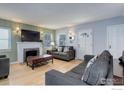Cozy living room with hardwood floors, fireplace, and natural light at 3441 W 45Th Ave, Denver, CO 80211