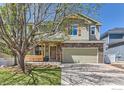 Beautiful home exterior with stone accents, a porch swing, and mature tree in the front yard at 4337 San Marco Dr, Longmont, CO 80503