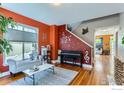 Cozy living room with hardwood floors, large window, and comfortable seating area at 4337 San Marco Dr, Longmont, CO 80503