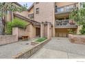 Charming building entrance with brick accents, lush greenery, and inviting architecture at 4475 Laguna Pl # 206, Boulder, CO 80303