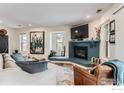 Comfortable living room with a stylish blue tiled fireplace and decorative artwork at 4475 Laguna Pl # 206, Boulder, CO 80303