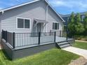 A spacious back deck with black railings and plenty of room for outdoor seating, perfect for entertaining at 4672 Clear Creek Dr, Longmont, CO 80504