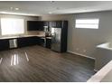 Modern kitchen boasts dark cabinets, stainless appliances, and an abundance of natural light at 4672 Clear Creek Dr, Longmont, CO 80504