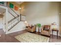 Spacious living area boasts hardwood floors, staircase and ample natural light at 4784 Raven Run, Broomfield, CO 80023