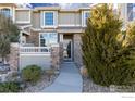 Charming townhouse featuring a stone facade, well-maintained landscaping, and a welcoming front entrance at 4822 Raven Run, Broomfield, CO 80023