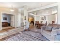 Open-concept living space with hardwood floors and plenty of natural light, perfect for entertaining and gatherings at 4835 Egret Dr, Frederick, CO 80504