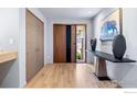 Contemporary entryway features hardwood floors, stylish console table, and closet at 50 Wildwood Ln, Boulder, CO 80304
