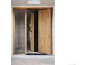Modern wood front door with sidelight and transom windows, welcoming natural light at 50 Wildwood Ln, Boulder, CO 80304