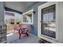 Inviting front porch featuring two chairs and a view of the neighborhood at 5822 Shenandoah Ave, Firestone, CO 80504