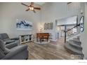 Bright living room featuring vaulted ceilings, light wood floors, and an elegant piano at 5822 Shenandoah Ave, Firestone, CO 80504