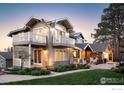 Charming exterior view of a home featuring stone accents, well-kept lawn, and inviting balconies at 709 Baseline Rd, Boulder, CO 80302