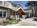 Charming exterior view of the home showcasing stone accents, a covered entrance, and landscaped garden beds at 709 Baseline Rd, Boulder, CO 80302