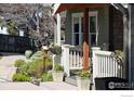 Well-maintained front yard featuring stone accents, flower pots, and manicured landscaping leading to the front porch at 709 Baseline Rd, Boulder, CO 80302