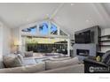 Bright living room features high ceilings, fireplace, and glass doors leading to a patio with mountain views at 709 Baseline Rd, Boulder, CO 80302